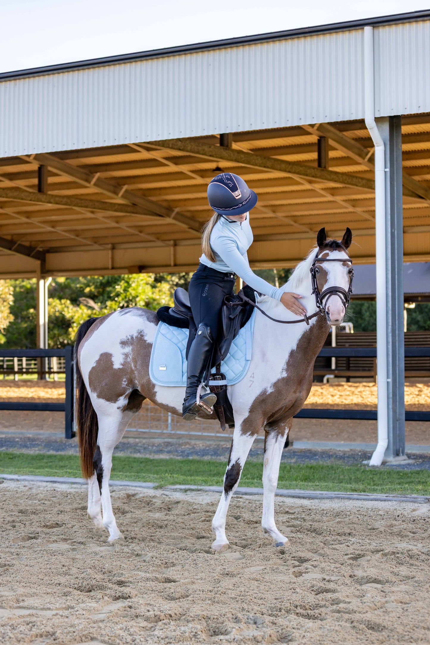 Light blue horse saddle pad featuring secure phone storage compartment