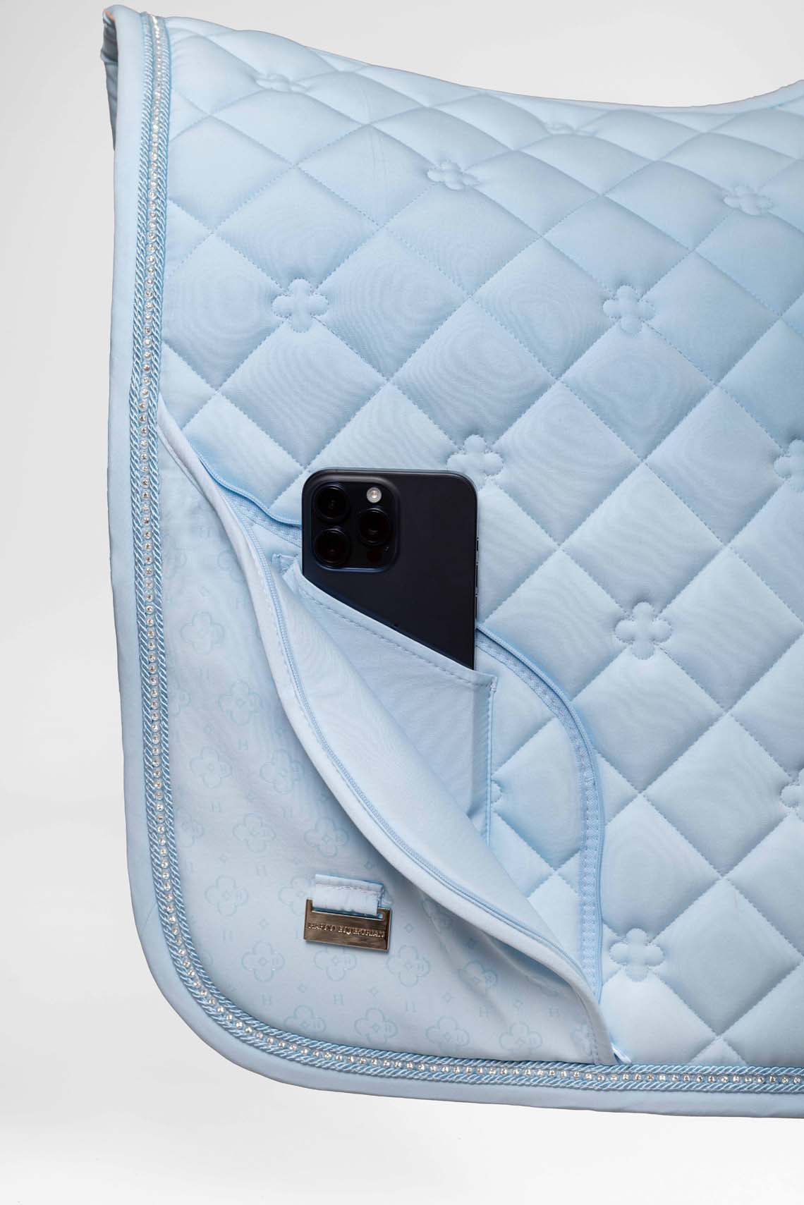Soft blue equestrian saddle pad with discreet phone storage