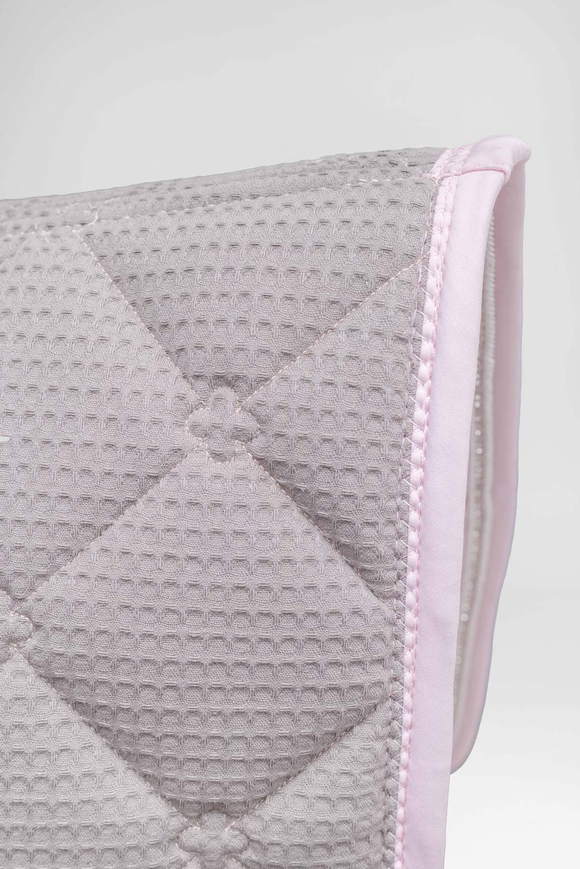 Baby pink saddle pad fabric showing quality of 100% cotton inner liner