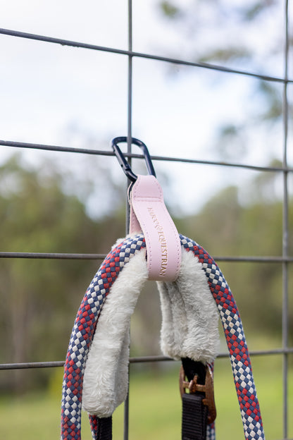 Pink Tack Mate mounted on paddock gates organising horse equipment